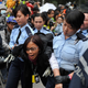 A protester is arrested and carried away by police officers during the 2014 protests